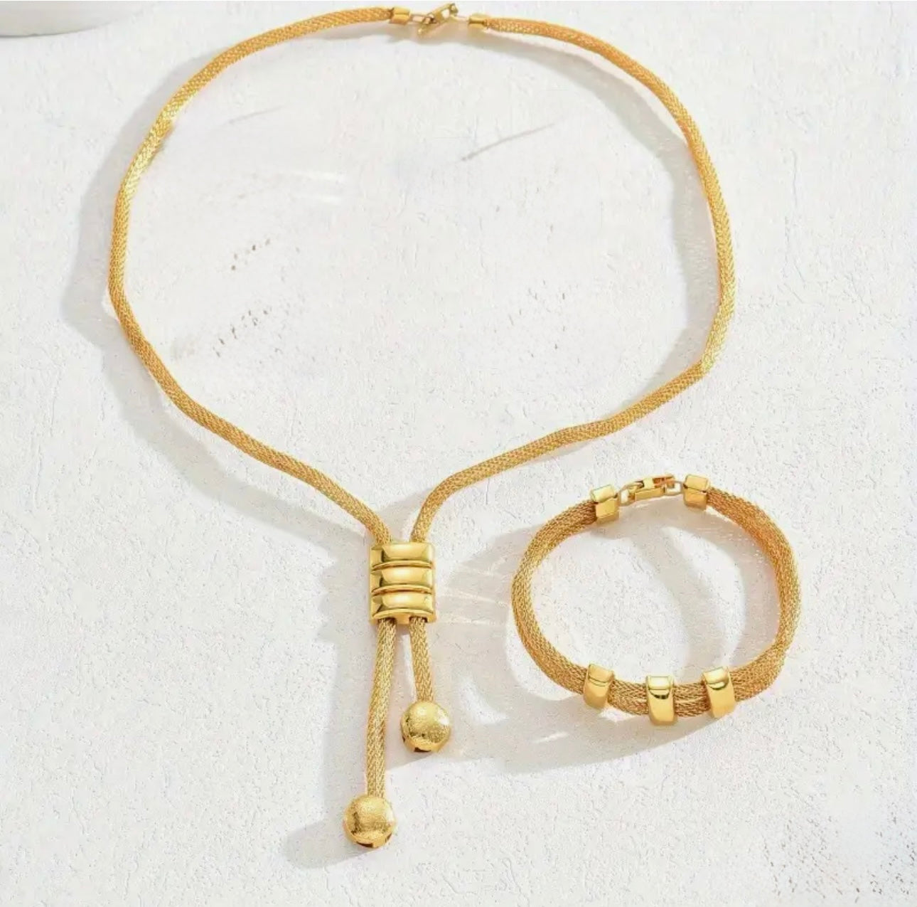 Sleek and sophisticated, gold-toned jewelry set